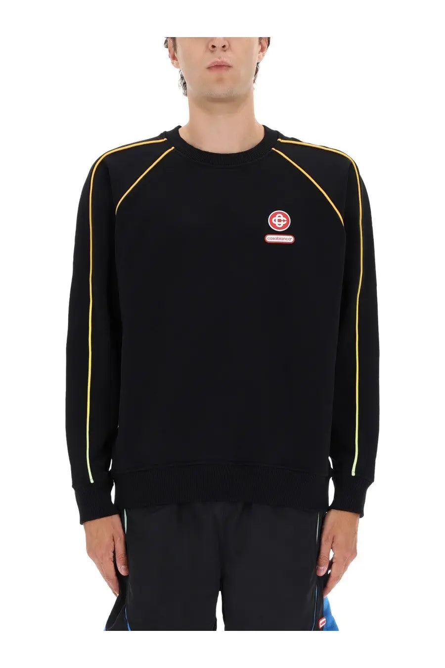 Casablanca men’s black crewneck sweatshirt with yellow piping and red circular logo patch on the chest