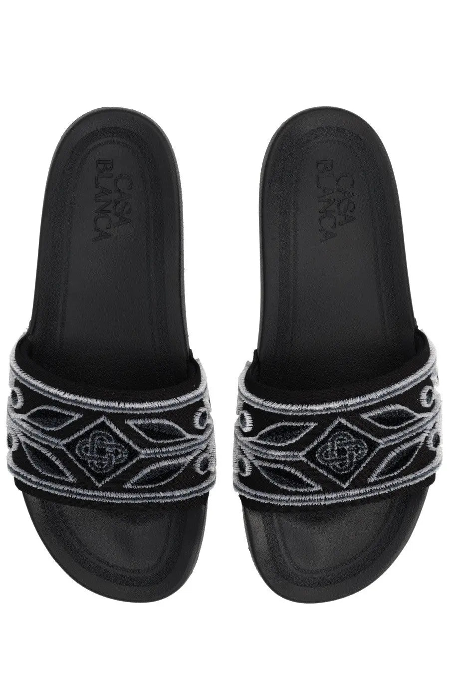 Casablanca unisex slide black sandals with a decorative white embroidered band featuring geometric and leaf patterns