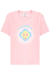 A soft pink short-sleeved t-shirt with a colorful smiling cloud and casablanca text on the front