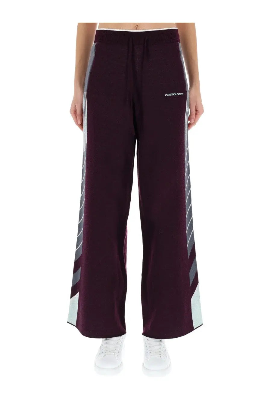 Casablanca women’s purple wide-leg track pants with gray and white diagonal stripes and drawstring waistband