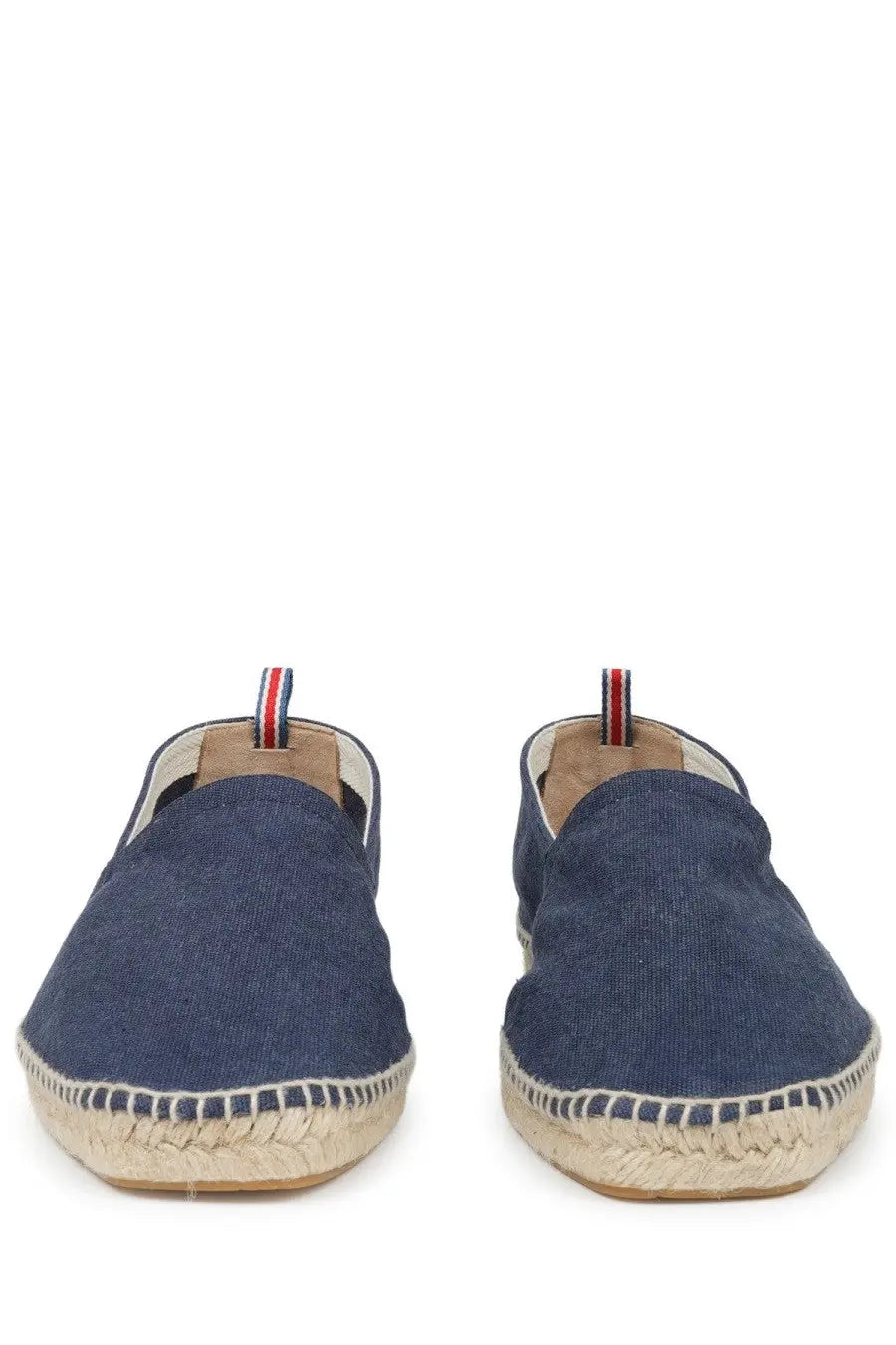 Navy blue canvas espadrille slip-on shoes with woven jute sole and red white and blue striped pull tab back view