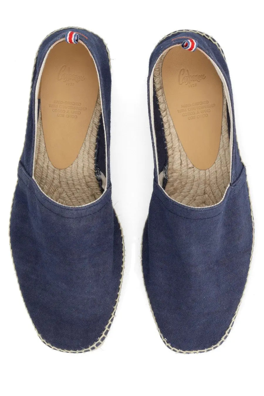 Navy blue canvas espadrilles with woven jute sole and red white and blue heel trim by castañer men’s espadrille pablo blue