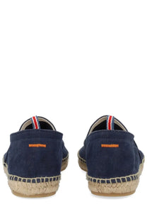 Navy blue canvas espadrille slip-on shoes with woven jute sole and striped heel tab shown from the back side