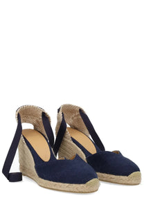 Navy blue canvas espadrille wedge sandals with woven jute sole and adjustable ankle strap by Castañer women’s clear blue