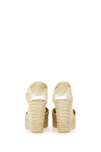 Beige woven espadrille wedge sandals with braided rope heel and ankle strap from castañer women’s espadrille clear gold