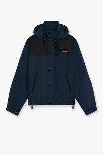 Celine men’s bicolor nylon jacket in navy blue and black with a contrasting chest panel and hooded design