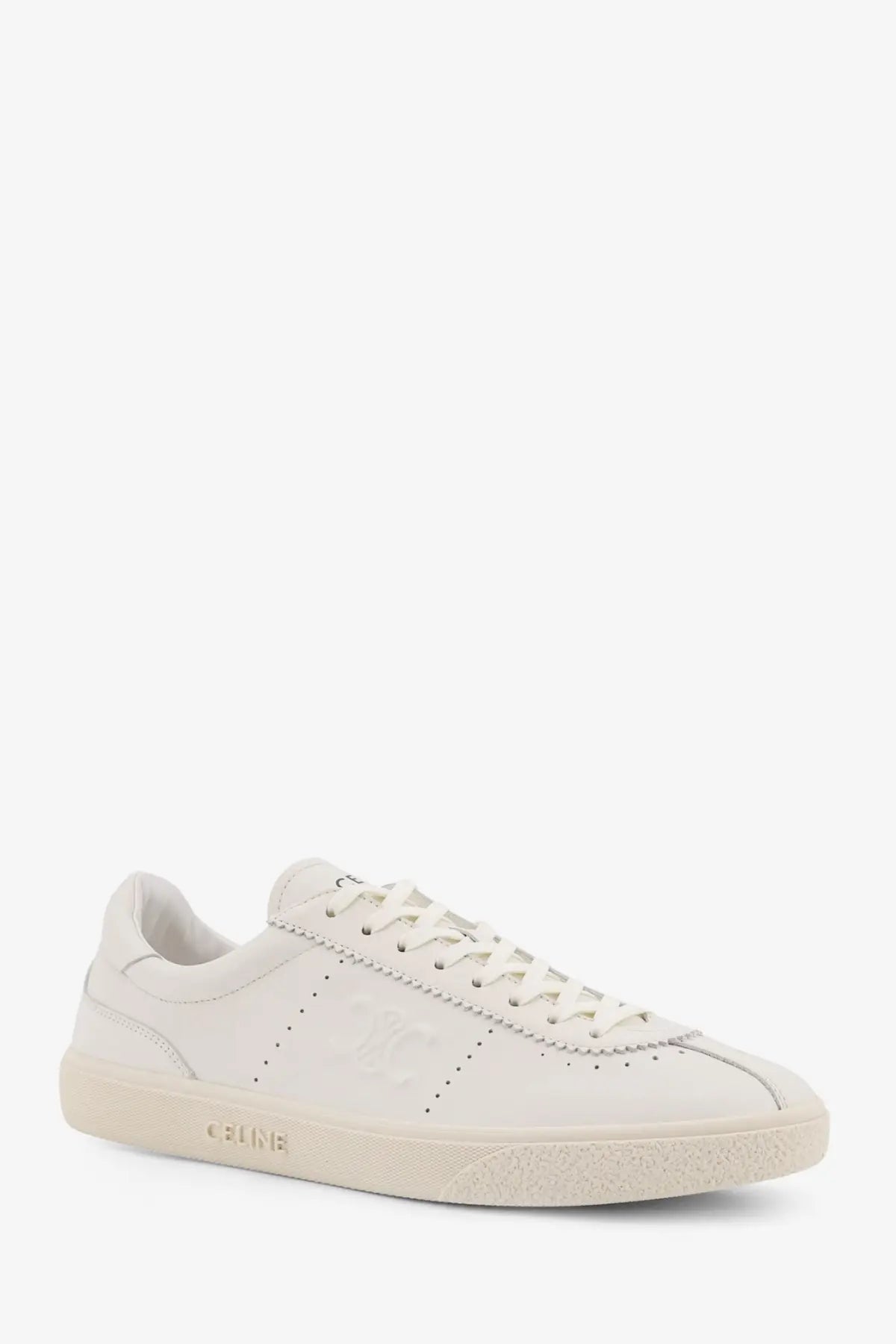 Celine men’s low top leather sneaker in cream suede with subtle perforated detailing and minimalist design