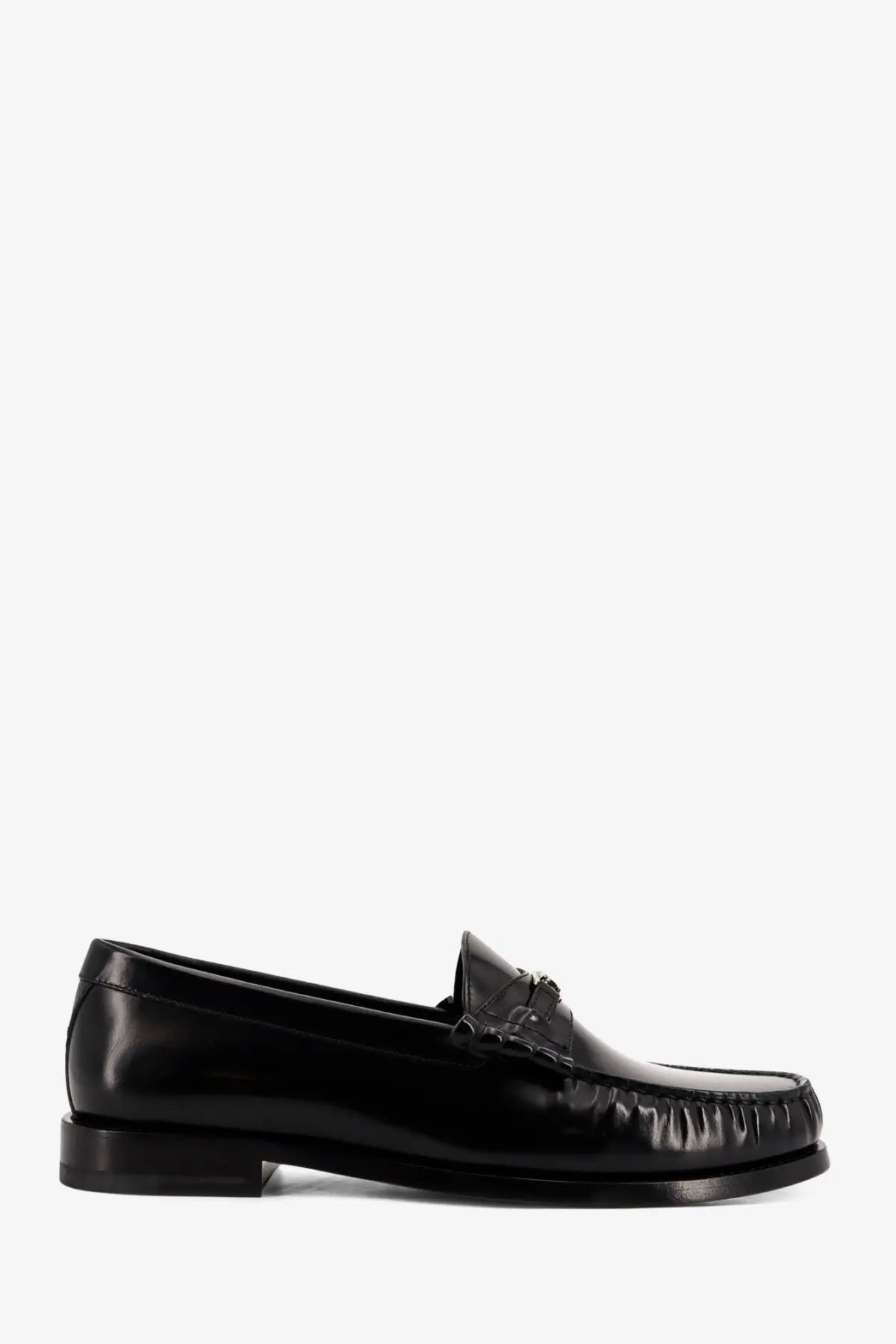 Black patent leather celine men’s loafer with polished finish and classic moccasin-style stitching