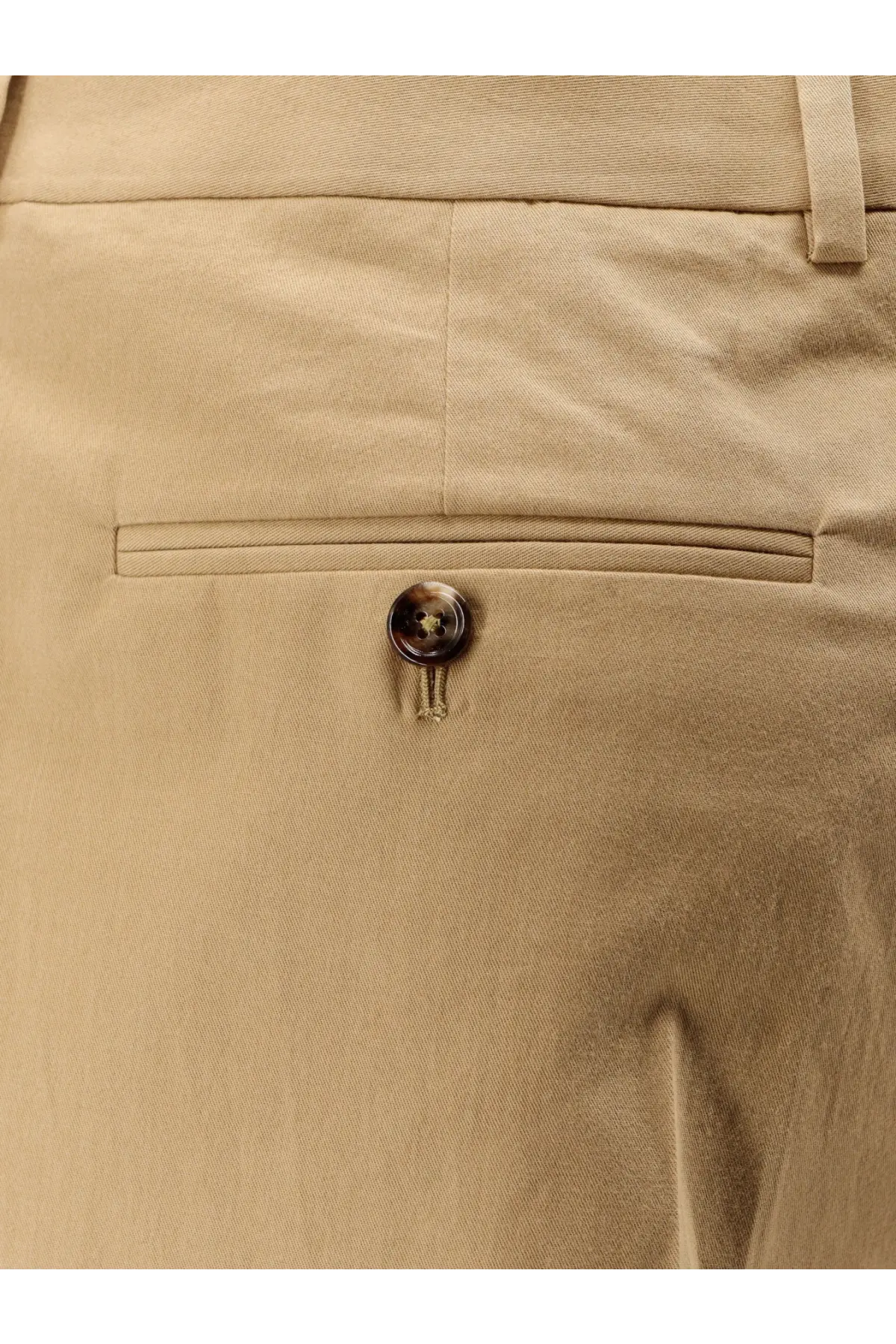 Back view of celine men’s beige pleated cotton trousers with subtle woven texture and dark brown button on back pocket