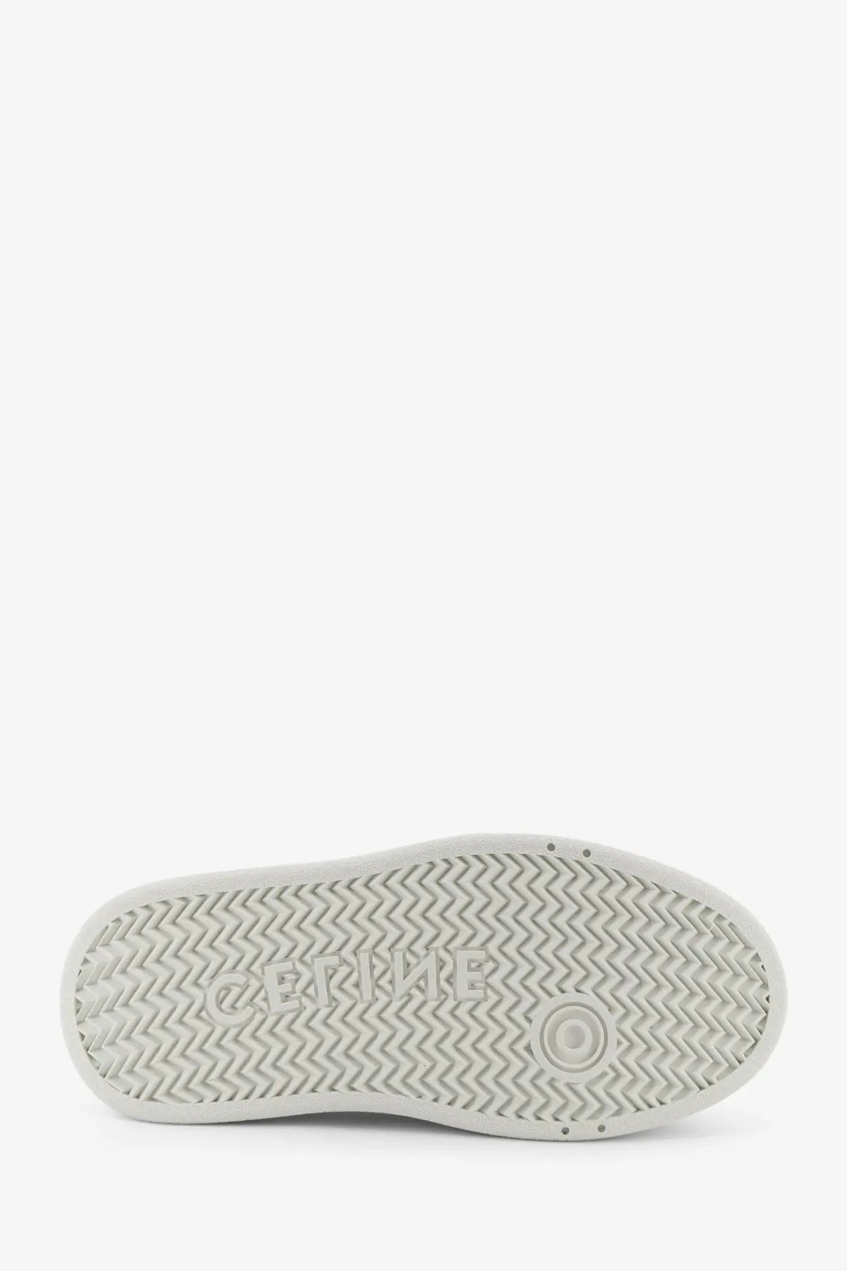 White celine women’s block sneakers with a white rubber sole featuring a zigzag pattern and embossed celine logo