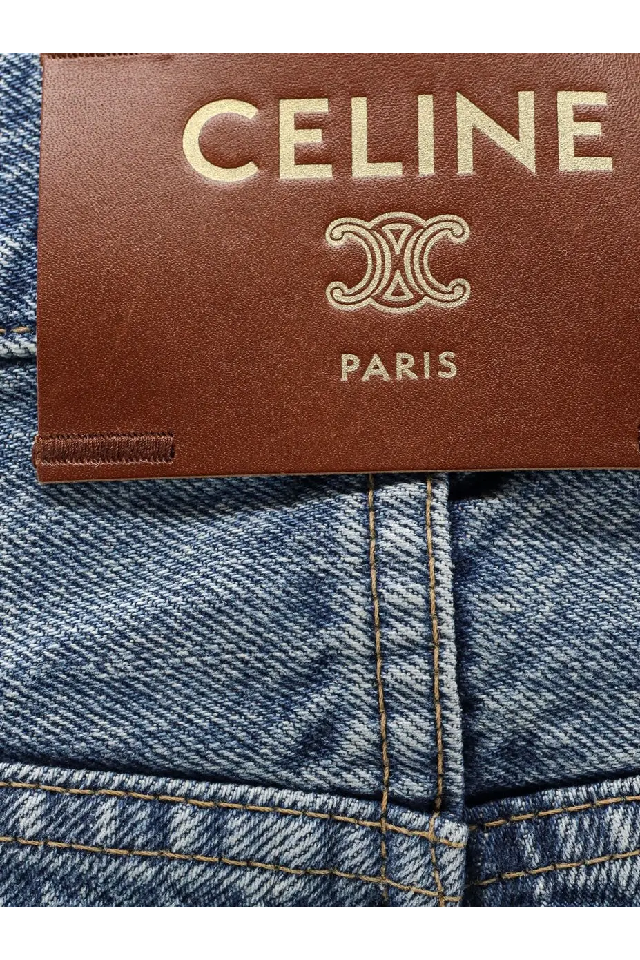 Celine women’s blue denim jeans made of denim with a brown leather brand tag visible on the back side