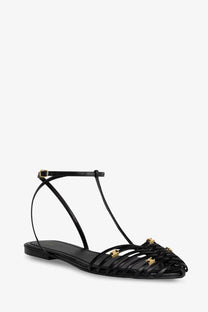 Celine women leather cage sandals black flat with t-strap design and gold-tone star-shaped embellishments