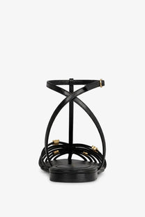 Celine women’s black leather cage sandals with strappy design and gold-tone hardware accents