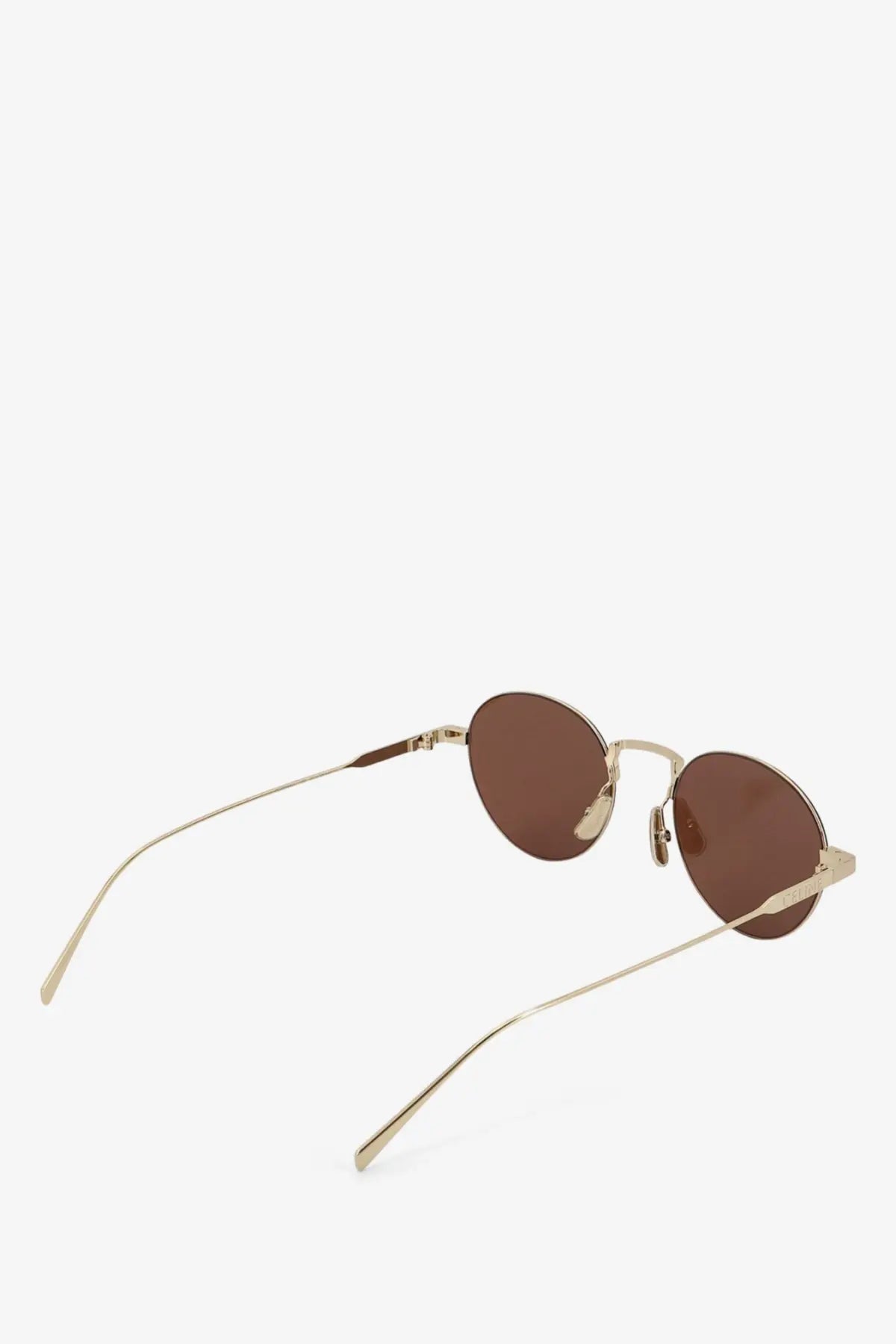 Celine women’s metal sunglasses with gold-toned round frames and brown lenses in a minimalist thin design