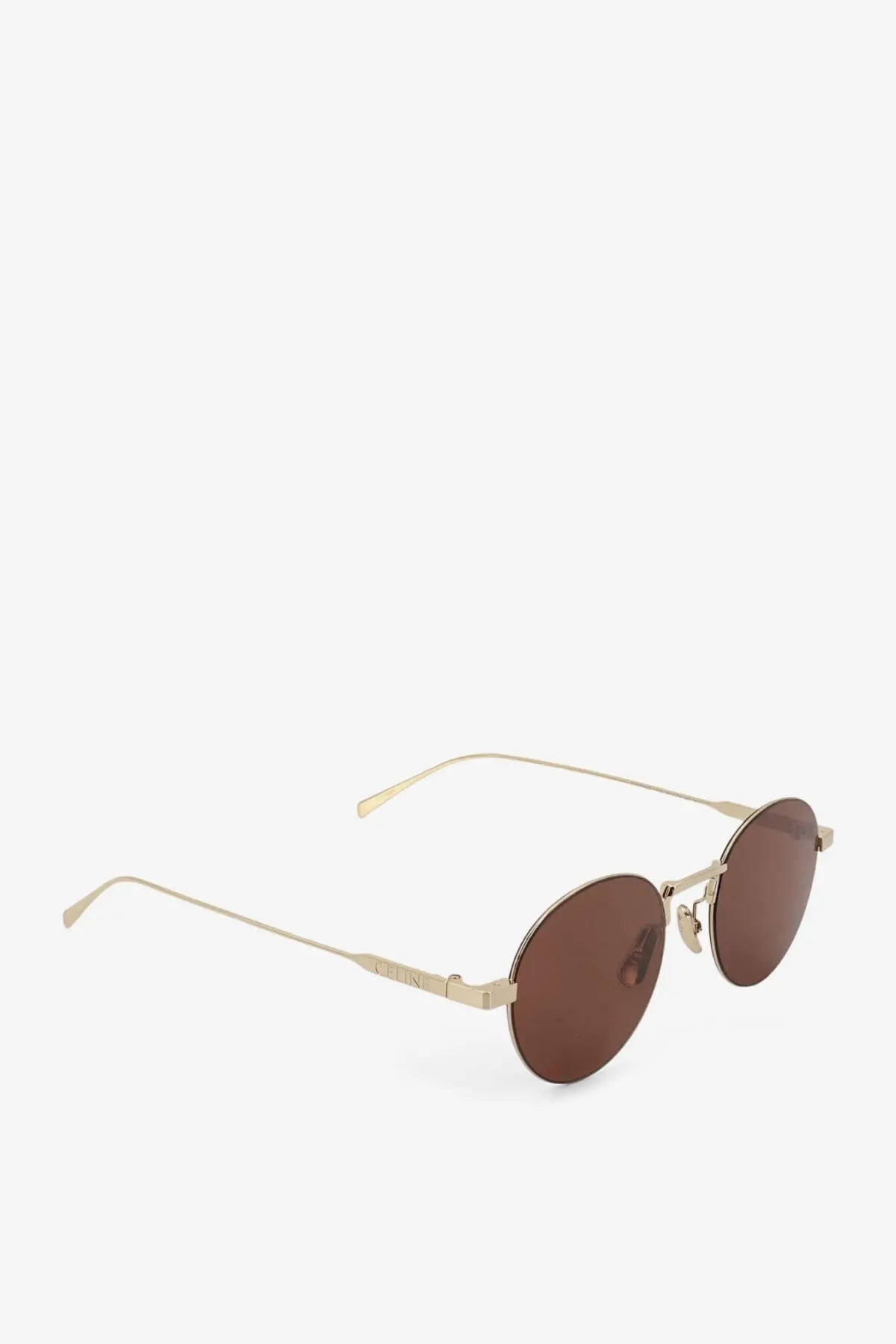 Celine women’s metal sunglasses featuring gold-toned round frames and brown lenses with a minimalist design