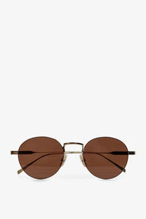 Celine women’s metal sunglasses with round brown-tinted lenses and gold-toned frame with black temple tips