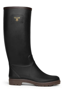 Black Celine women’s rubber rainboot with brown sole and trim designed for wet weather use