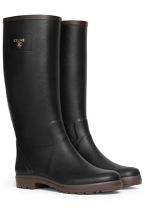 Black celine women’s rainboot made of rubber with brown soles and trim designed for wet weather use