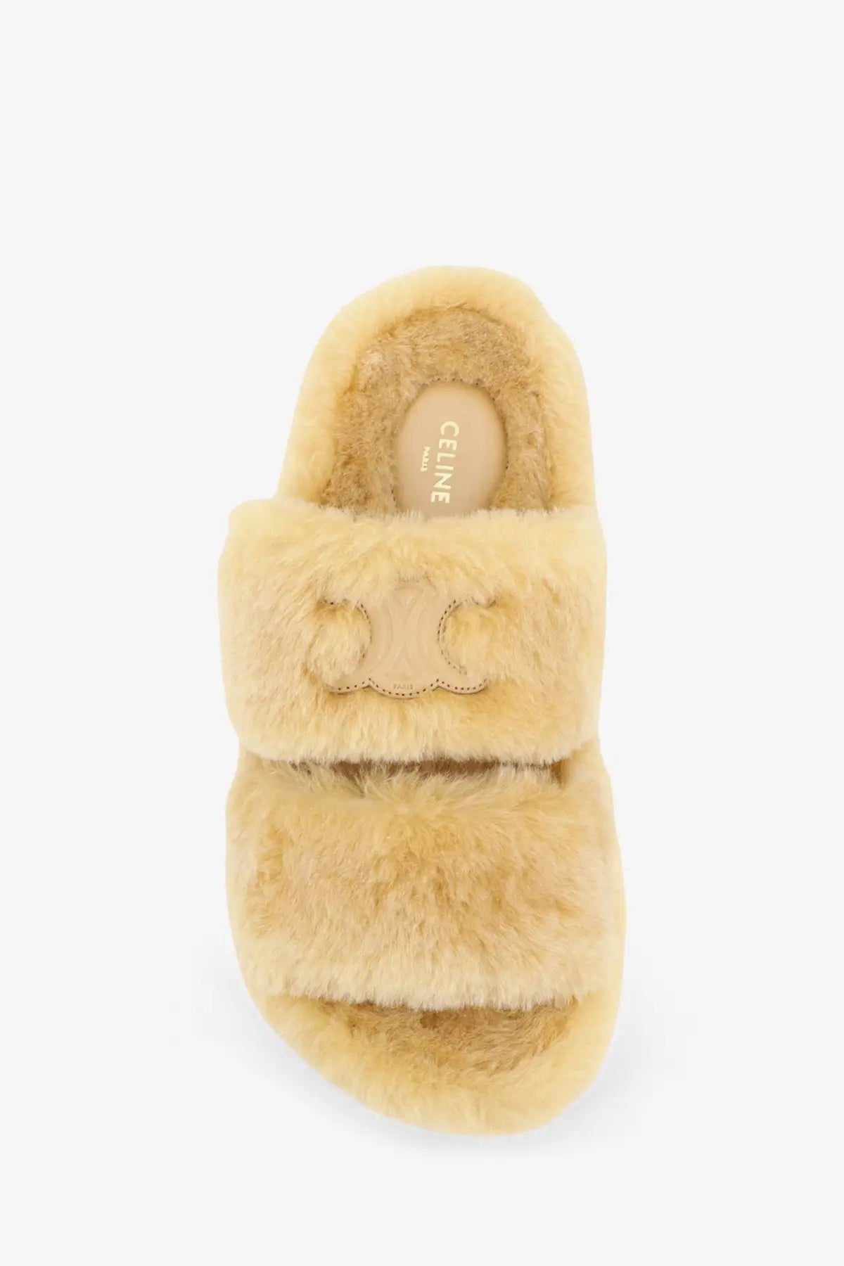 Beige celine women’s triomphe slide shearling sandals with plush two-strap design and embroidered logo detail