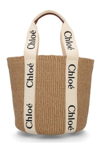Beige woven straw tote bag with cream handles black chloé lettering and brown leather accents chloé women’s borsa woody large white