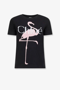 Black short-sleeved cotton t-shirt for women featuring a pink flamingo graphic with chloé branding across its body