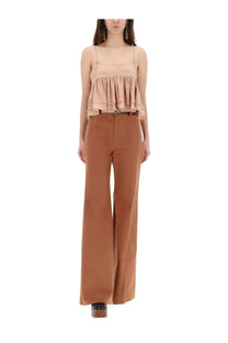 Beige ruffled spaghetti strap top with delicate gold tone hardware at the neckline paired with chloé brown flared pants