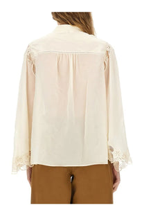 Chloé women’s cream-colored fluid silk georgette blouse with delicate lace trim along shoulders and cuffs