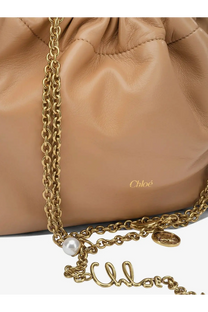 Beige leather Chloé women’s crossbody bag with drawstring closure gold-tone chain strap and black-stitched handles