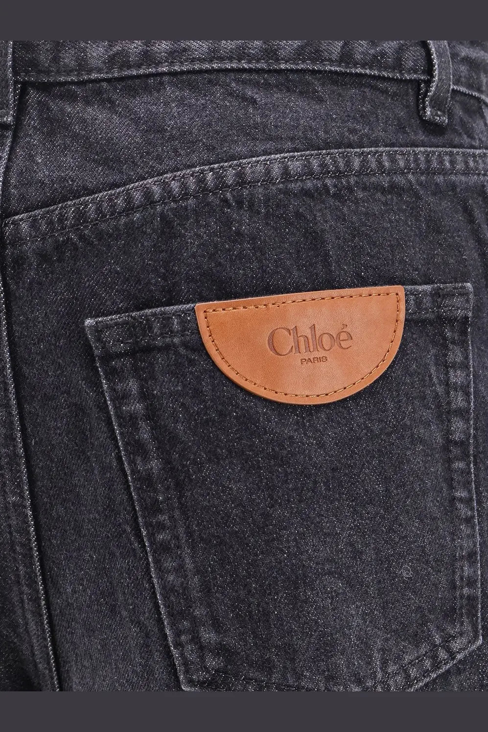 Dark-wash denim jeans with tan leather patch embossed chloé paris on the back for women in black color