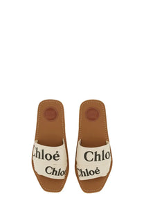 Cream-colored canvas slide sandals with brown leather accents and chloé branding for women woody white model