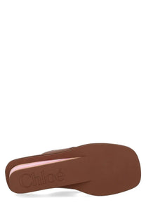 Brown leather chloé women’s slide sandal with minimalist design and subtle pink inner lining in swimming cool brown