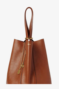 Brown leather tote bag with gold-tone hardware and chain detail from Chloé women’s Chloé spin collection