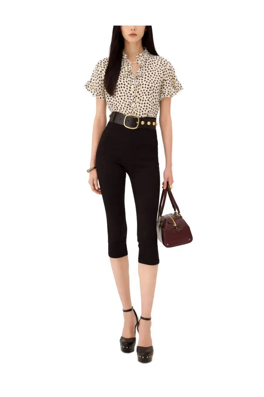 A woman wears a chloé women’s beige top with black polka dots short flutter sleeves and a ruffled collar