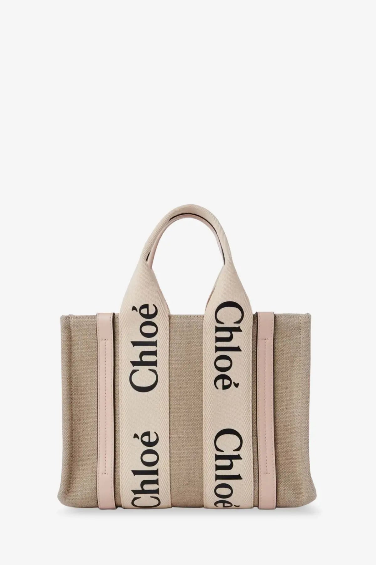 Beige canvas chloé women’s tote bag with pink leather trim and black lettering on handles