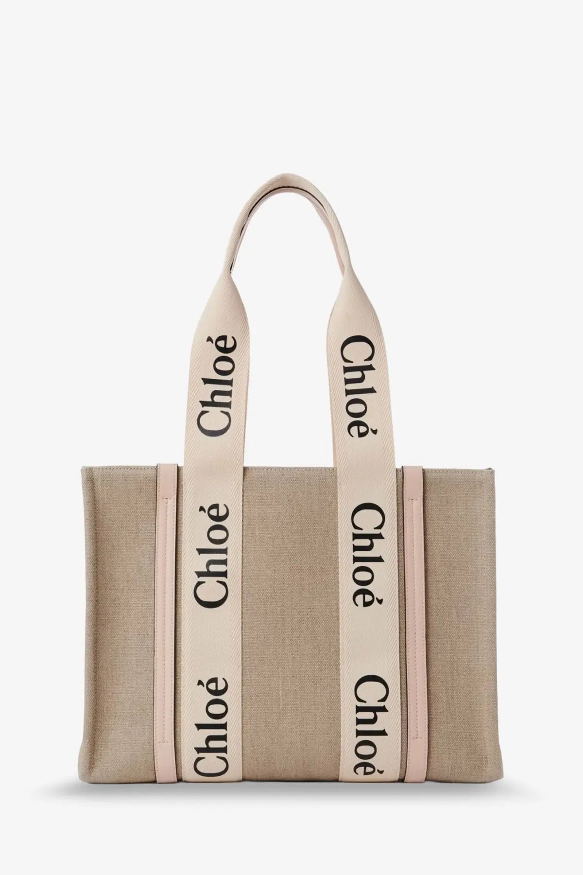 Beige canvas tote bag with cream straps featuring black chloé lettering from the chloé women’s woody linen shoulder bag blue collection