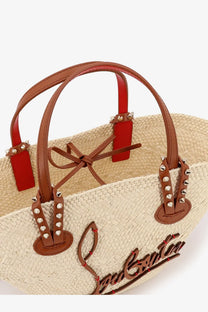 Christian Louboutin womens Cabata raffia handbag beige straw tote with brown leather handles red accents and silver studs