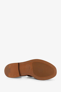 Brown leather sole with stitched edges and embossed logo on churchs men’s orange suede fisherman sandals back side