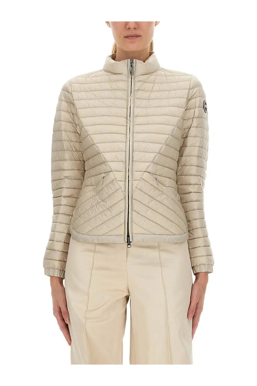 Beige quilted lightweight down puffer jacket for women by Colmar with high collar and front zipper closure