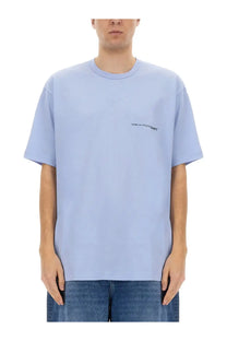 Light blue Comme Des Garcons men’s shirt with subtle black logo on left chest in cotton blend fabric