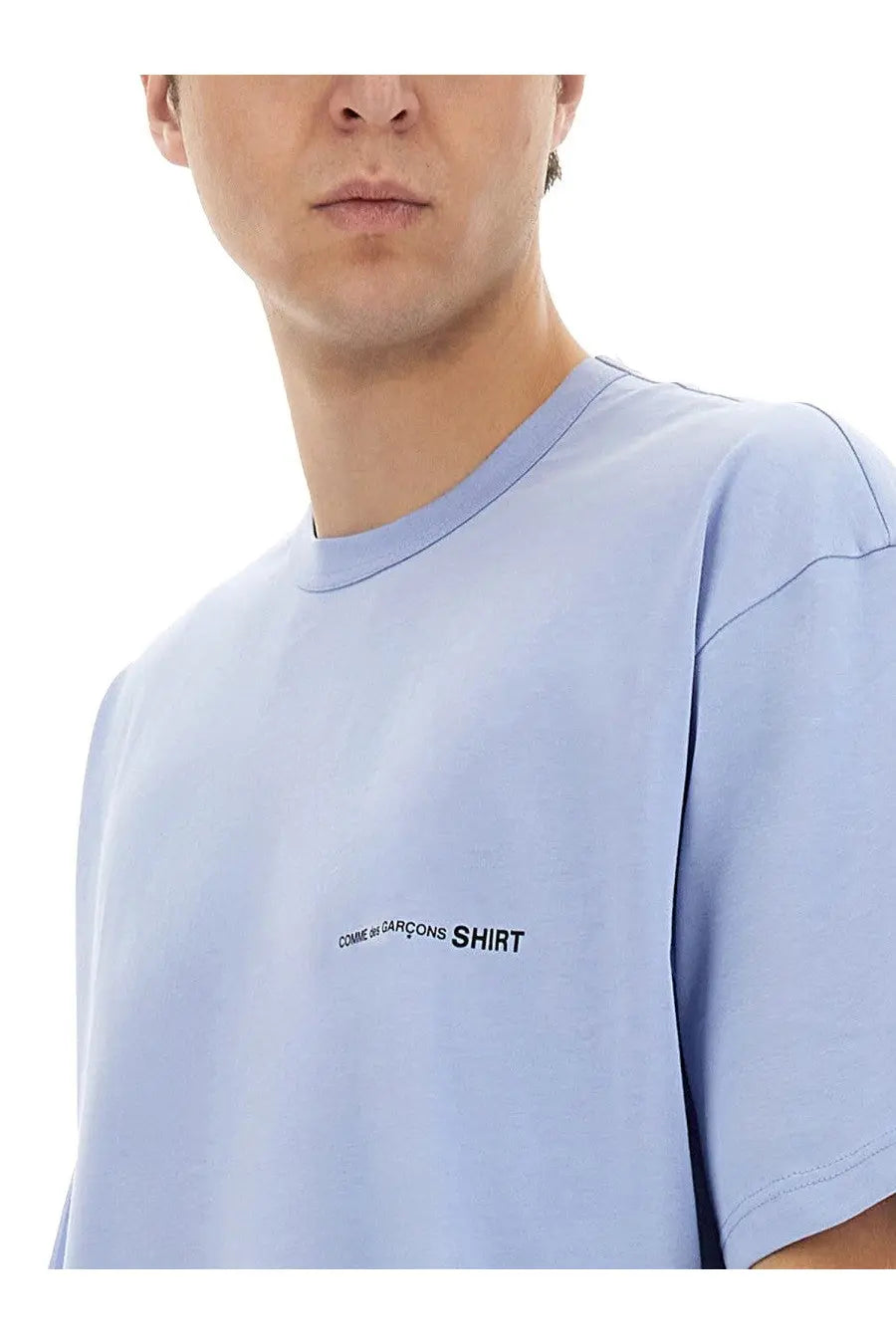 Light blue comme des garçons men’s shirt with black text logo on the chest for casual wear