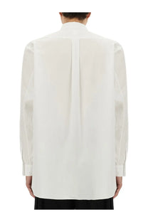 White poplin long-sleeved comme des garcons shirt with structured collar and subtle pleats on the back side