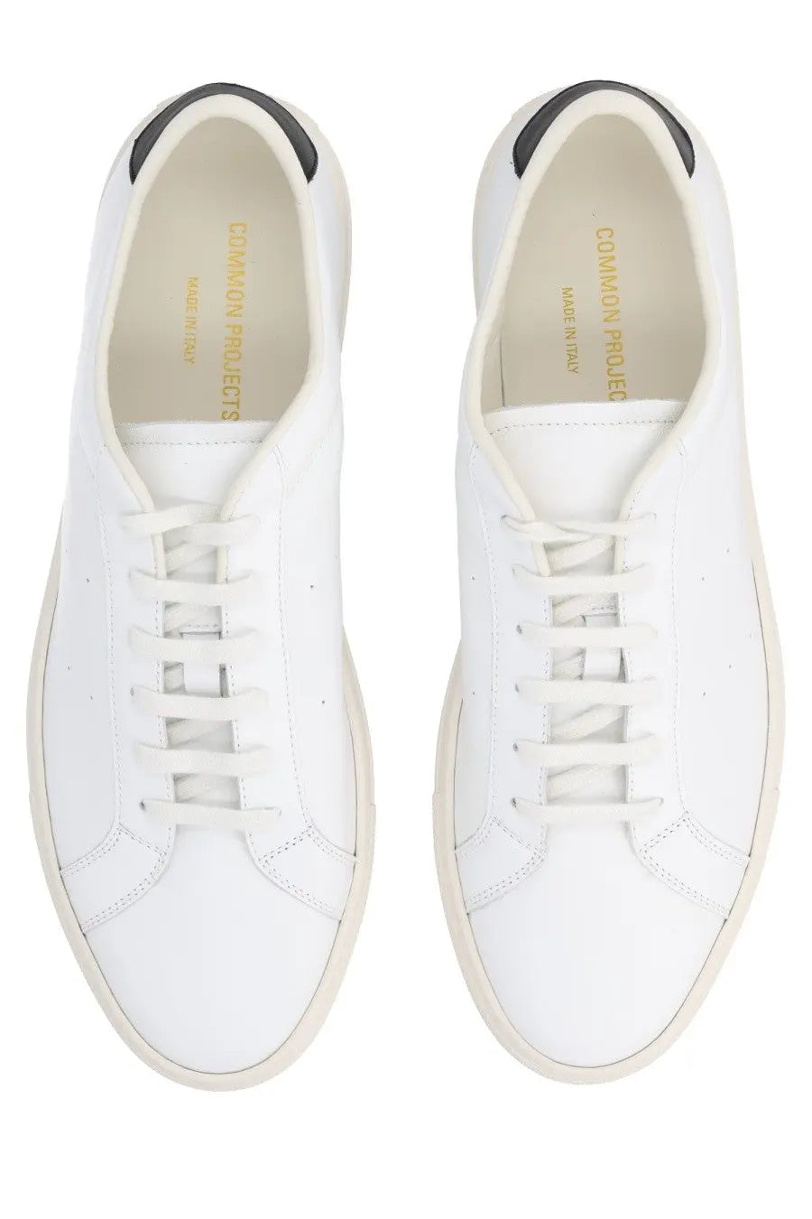 Common projects men’s sneaker achilles white leather with black heel tabs and cream soles minimalist design back view