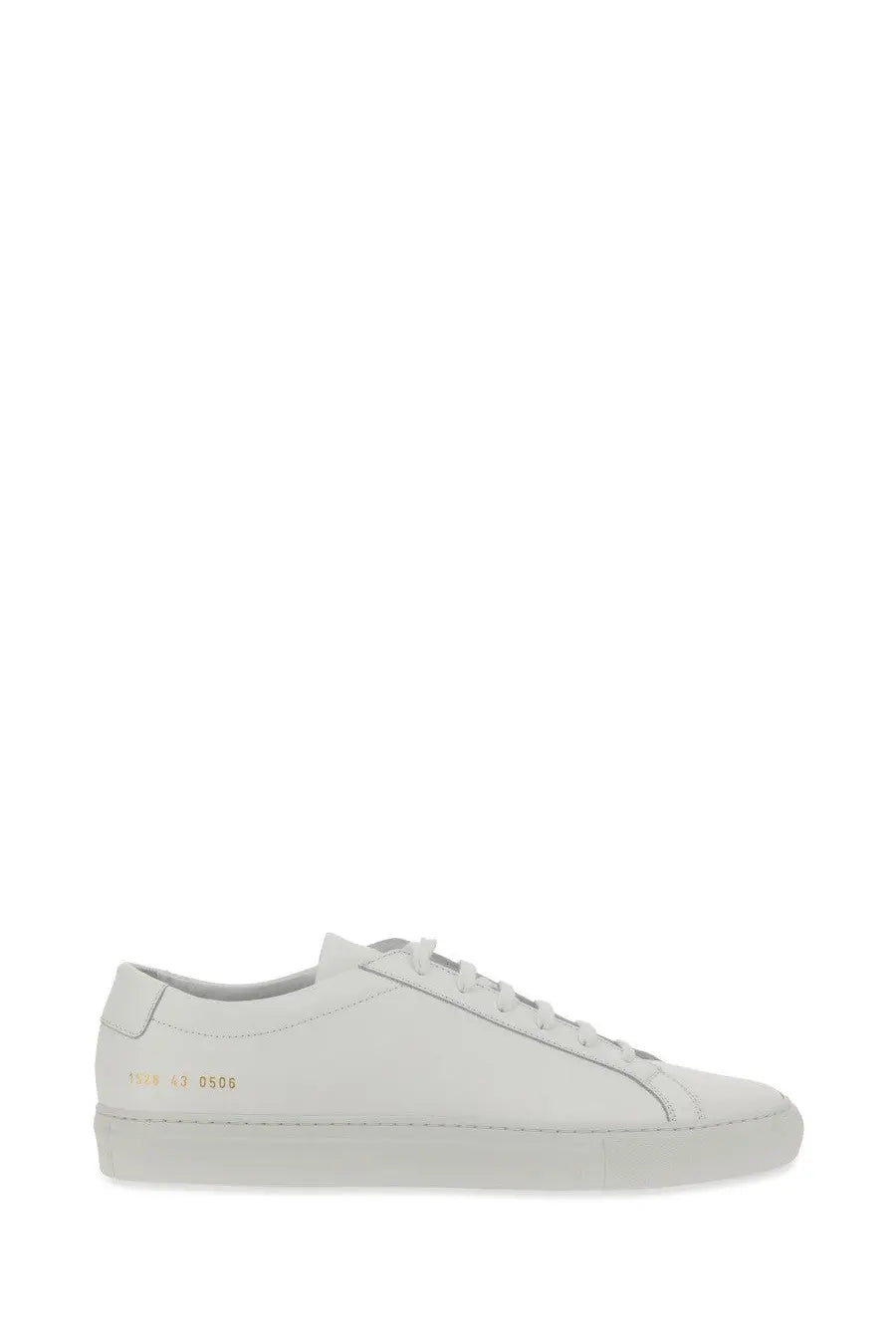 Common projects men’s low-top white leather sneaker with minimalist design and subtle gold branding on the heel back side