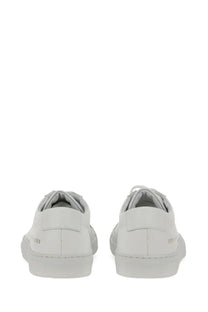 Common projects women’s low original achilles sneaker white leather low-top with minimalist design and subtle heel branding shown from back
