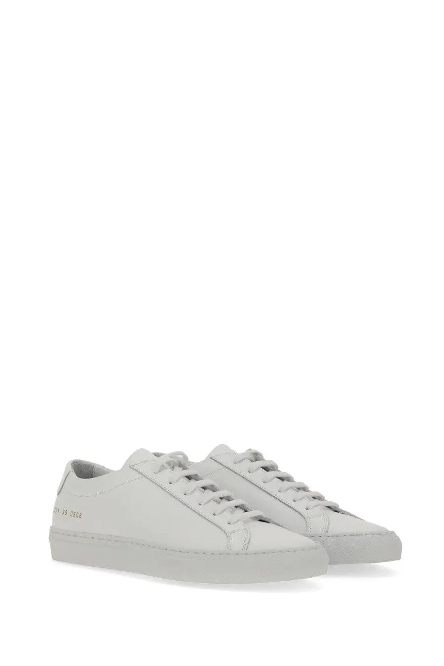 Common projects women’s low original achilles sneaker white leather low-top with minimalist design and subtle heel branding viewed from the back