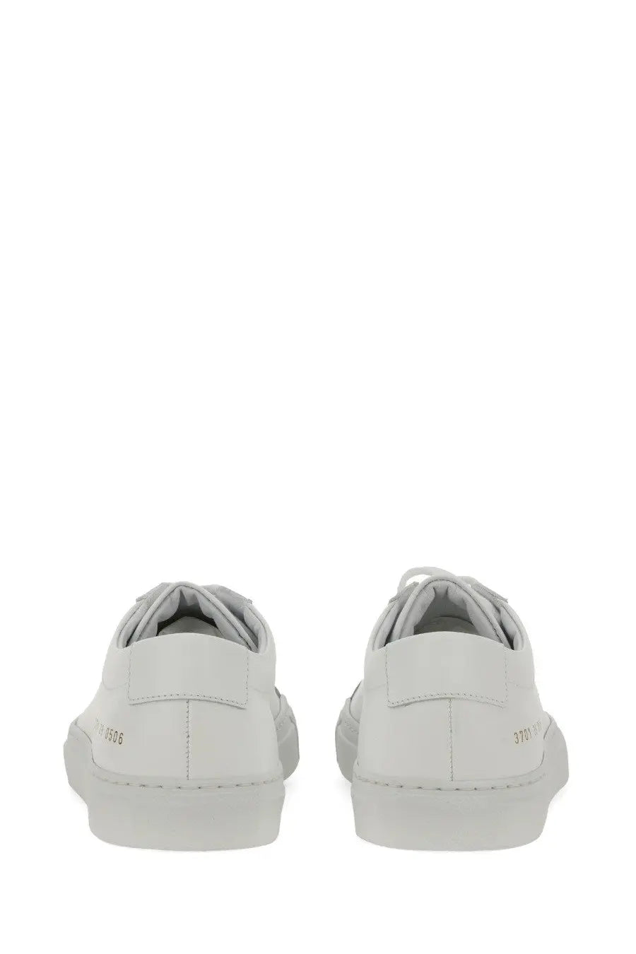 Common projects women’s low original achilles sneaker white leather low-top with minimalist design and subtle heel branding from back view