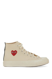 Cream-colored Converse unisex high-top sneaker with bold red heart and black eyes embroidered on the side