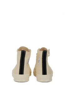Cream-colored converse unisex high-top sneakers with black side stripes and classic logo on the back heel