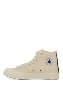 Cream-colored Converse All Star high-top sneaker with classic rubber toe cap and black heel tab in unisex white design