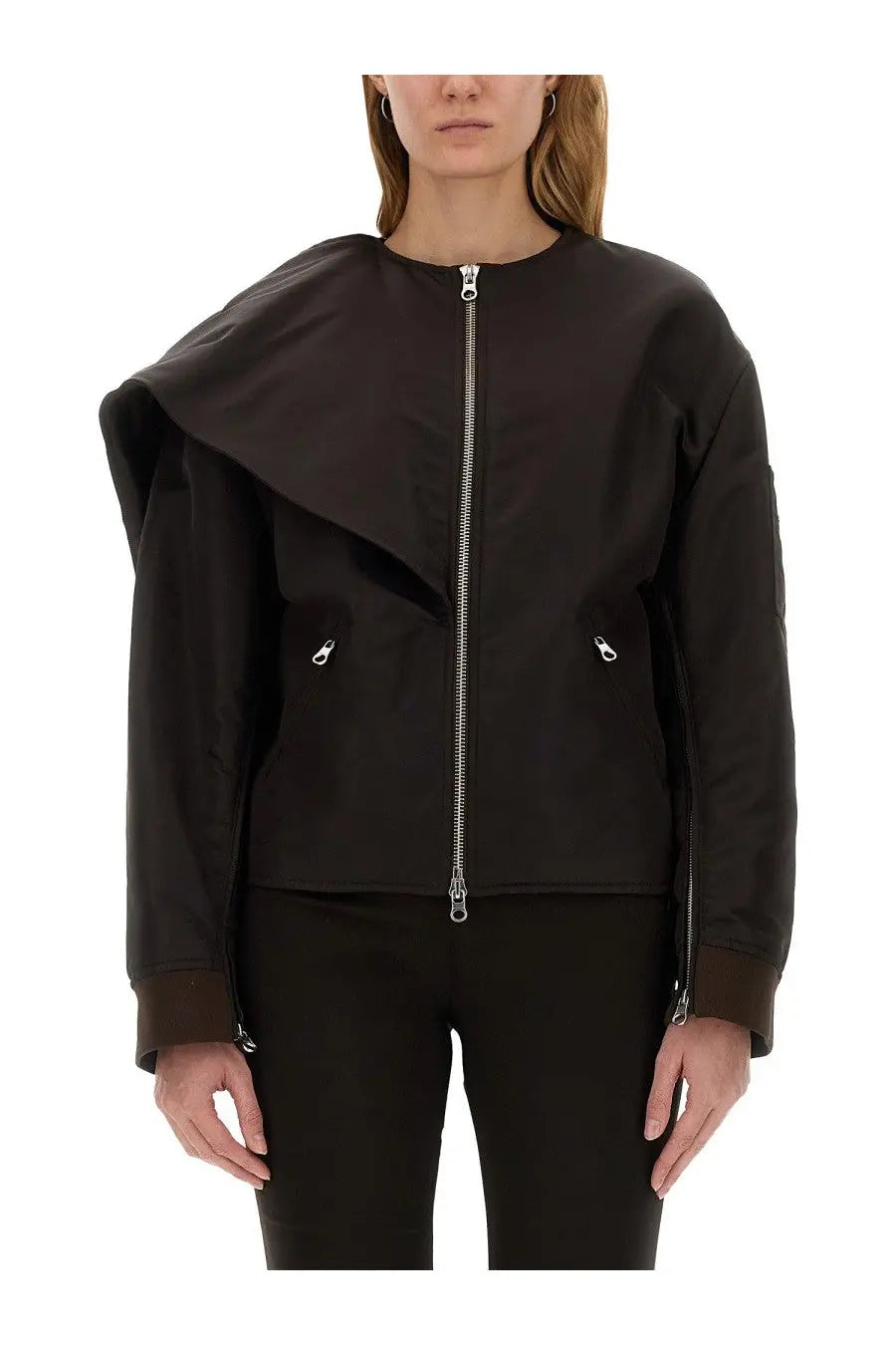 Woman wearing black asymmetrical bomber jacket with silver zippers and subtle texture by courrèges